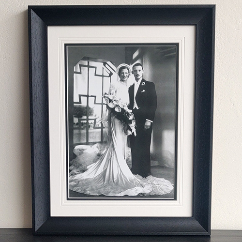 Restored wedding photo from 1933 in a black scooped frame with V-groove mount