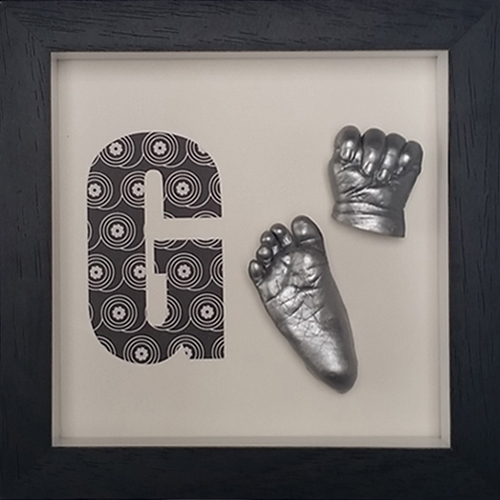 Silver casts with initial letter in a Contemporary black frame