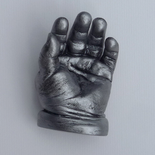 Antique silver hand cast of an 8 month old