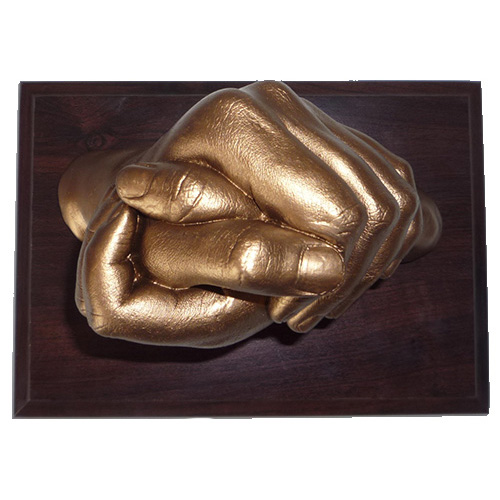 Gold clasped hands cast of 7 and 10 year old siblings