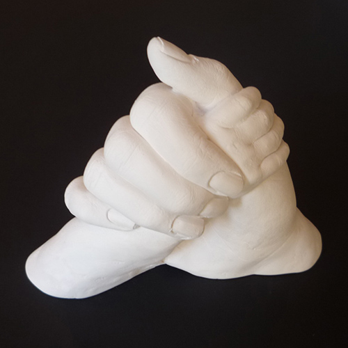Mother and baby clasped hands statuette