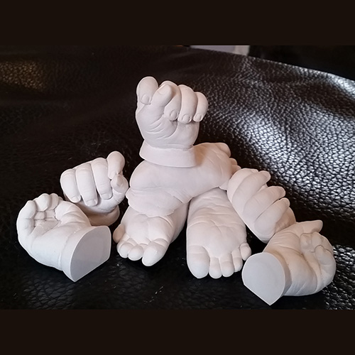A pile of hand and foot casts of a 3 month old ready for painting