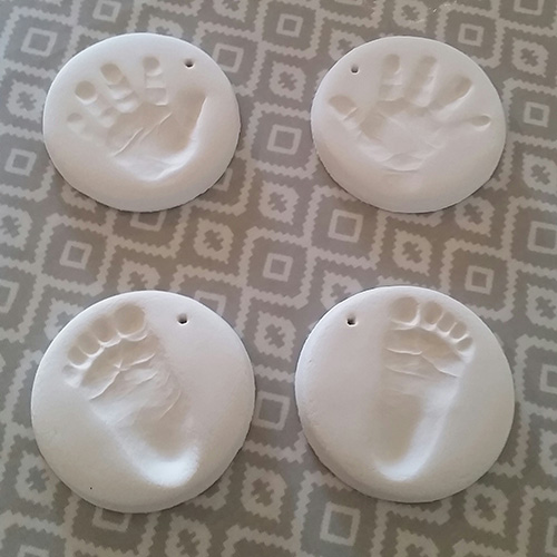 4 white clay hand and footprints to hang