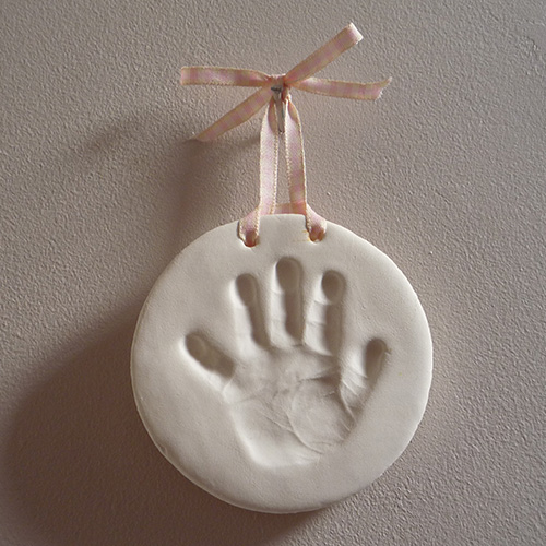 Handprint impression in white clay to hang